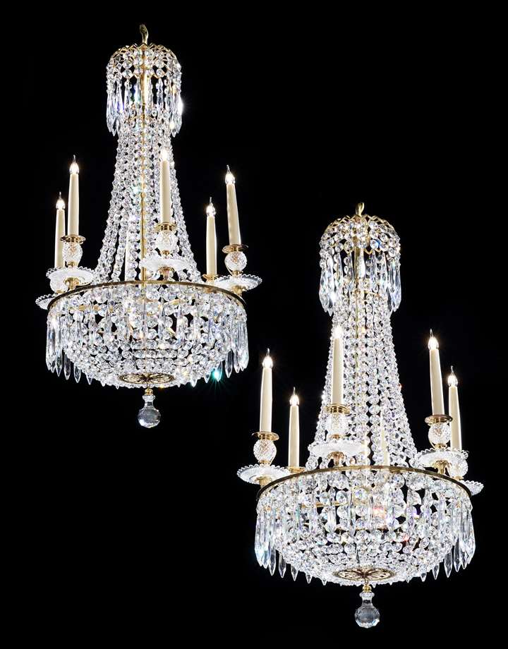 A small pair of regency cut glass six light chandeliers